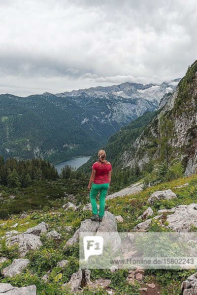Hiker looks at Vorderer Gosausee and Dachstein massif  Dachstein  Salzkammergut  Upper Austria  Austria  Europe