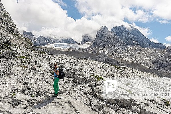 Hiker  alpine landscape  Great Gosau Glacier  Dachstein and Torstein  Salzkammergut  Upper Austria  Austria  Europe