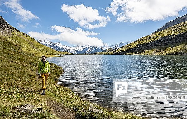 Hikers at Bachalpsee  Schreckhorn and Finsteraarhorn summits  Grindelwald  Bernese Oberland  Switzerland  Europe