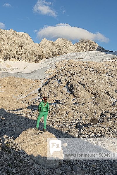 Hiker looks at alpine landscape  Great Gosau Glacier  High and Low Dachstein  Salzkammergut  Upper Austria  Austria  Europe
