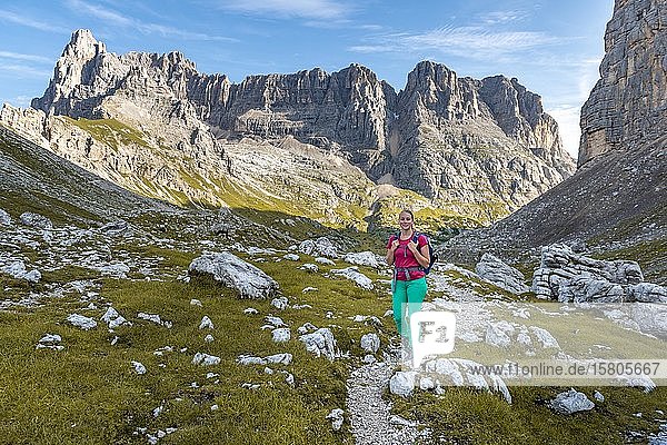 Young hiker on a hiking trail  Sorapiss Circumambulation  behind ridge  Mount Punte Tre Sorelle  Dolomites  Belluno  Italy  Europe