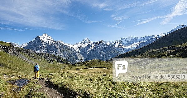 Hiker  snow-covered Fiescherhorn  Wetterhorn and Schreckhorn  Grindelwald  Bern  Switzerland  Europe