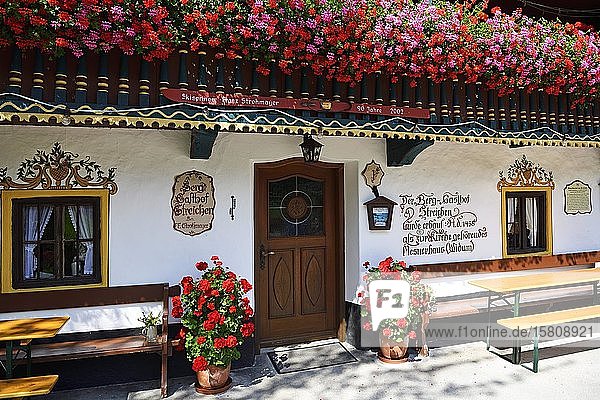 Lüftlmalerei and flowering geraniums alpine restaurant Streichen Schleching Chiemgau Upper Bavaria Bavaria Germany Europe