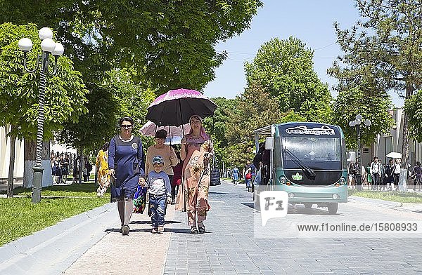 Walker with parasol and golf card on Tashkent Street  pedestrian zone  Samarkand  Samarqand Province  Uzbekistan  Asia