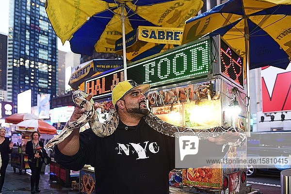 New Yorker gets photographed with Python Times Square Manhattan New York City New York State USA North America