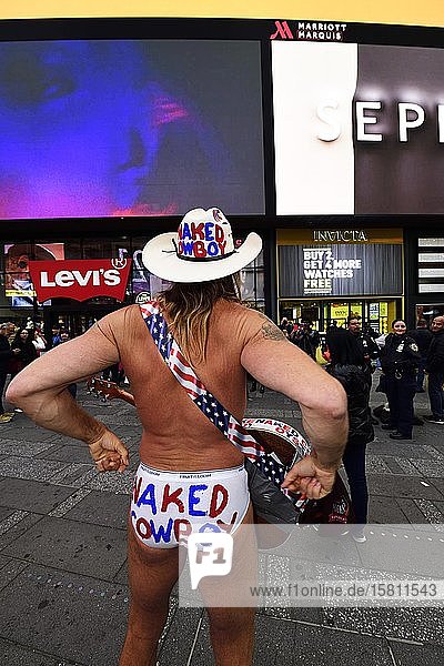 Robert Burck  the naked cowboy  is having his picture taken with tourists in Times Square  Manhattan  New York City  New York State  USA  North America