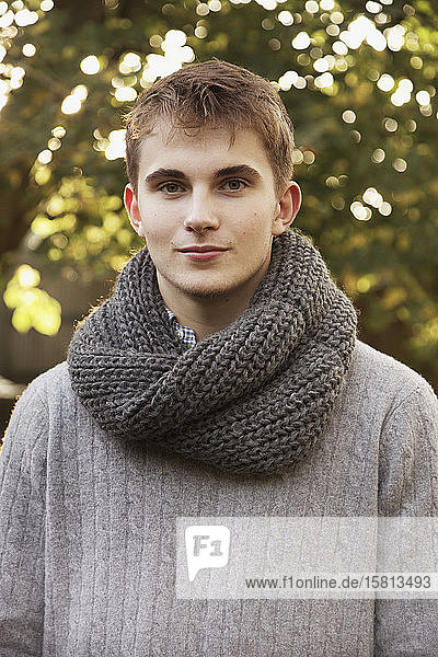 Portrait confident teenage boy with scarf