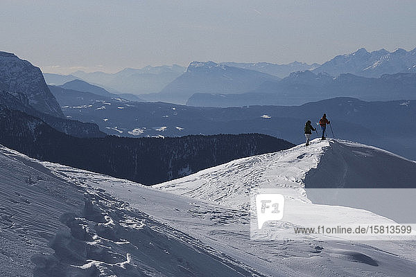 Couple hiking on sunny  scenic snowy mountain  Brixen  South Tyrol  Italy