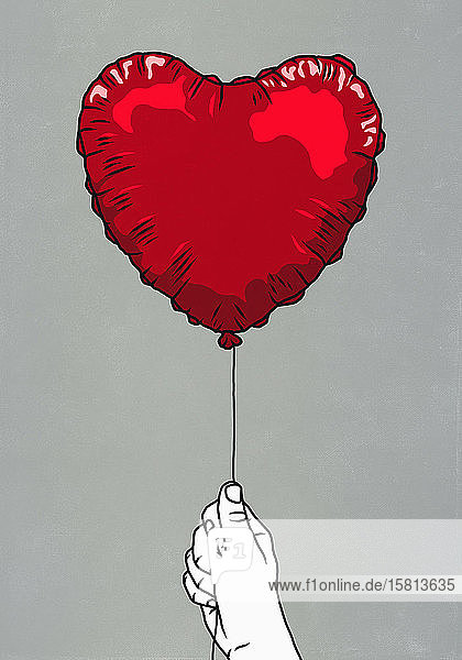 Hand hält roten Herzform Ballon