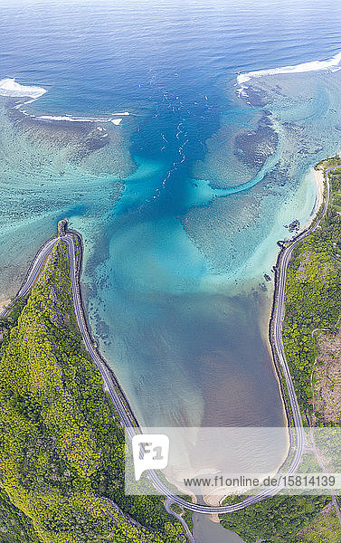 Coastal road facing the turquoise lagoon aerial view by drone Bel Ombre Baie Du Cap South Mauritius Indian Ocean Africa