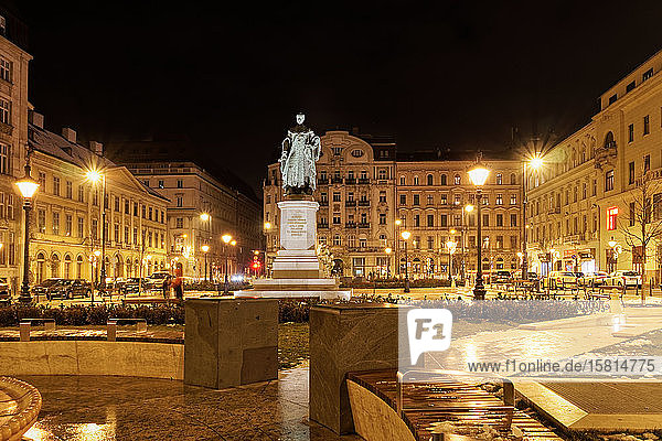 Jozsef Nador Ter Palatine Square at night with buildings and Joseph Archduke of Austria and Hungary statue  Budapest  Hungary  Europe