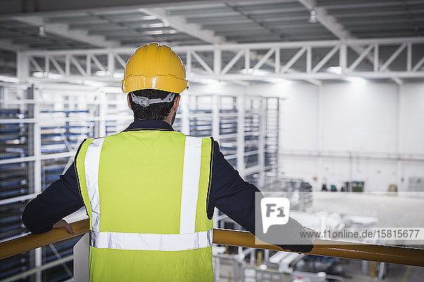 Male supervisor on platform in factory
