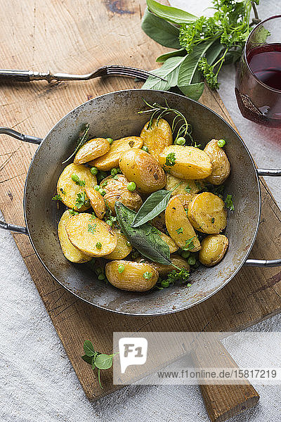Caramelised new potatoes with peas and fresh herbs