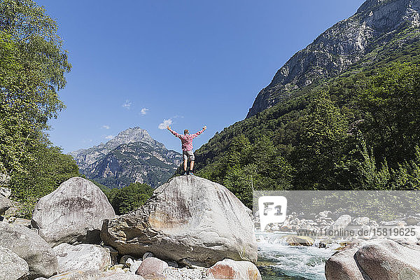 Man standing on rock at Verzasca river  Verzasca Valley  Ticino  Switzerland