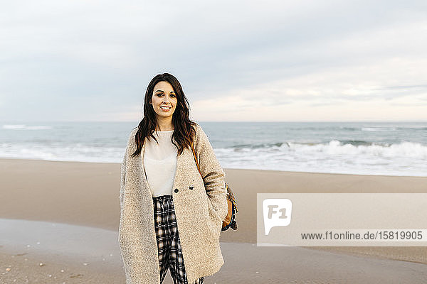 Portrait of a young woman on a remote beach at sunset