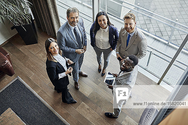Portrait of confident business team standing in hotel lobby