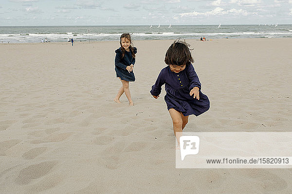 Two little girls playing on the beach  Scheveningen  Netherlands