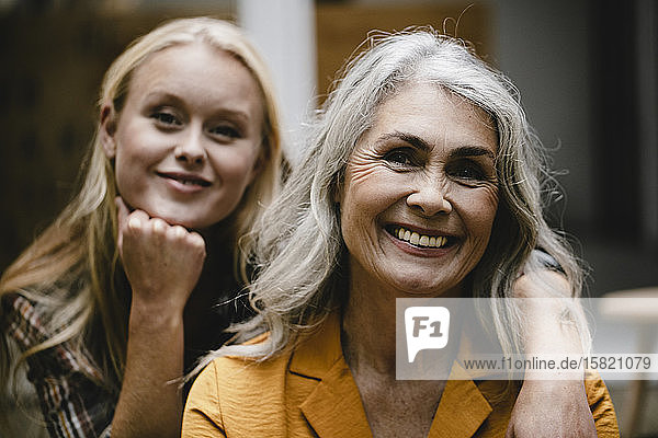 Portrait of smiling mother and adult daughter
