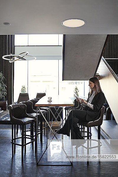 Businesswoman using tablet in hotel lobby