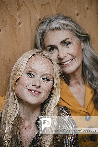 Portrait of smiling mother and adult daughter