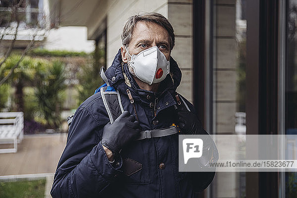 Matuer man commuting in the city wearing protective mask