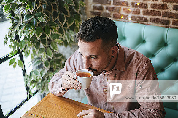 Man in a cafe drinking cup of tea