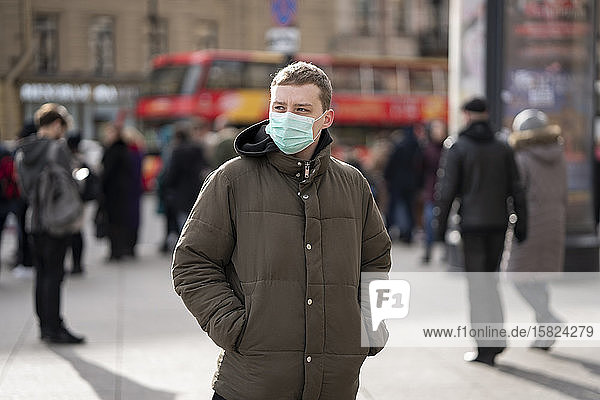 Young man with face mask  commuting in the city  St. Petersburg  Russia