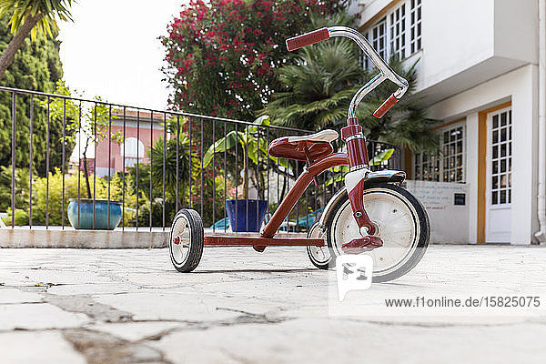 France  Alpes-Maritimes  Cagnes-sur-Mer  Red tricycle left outdoors