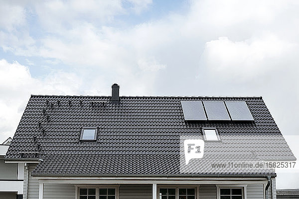 Rooftop of one-family house with three solar panels  Germany