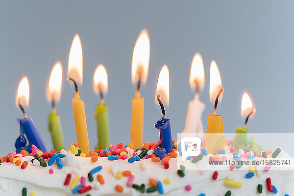 Lit birthday candles on cake