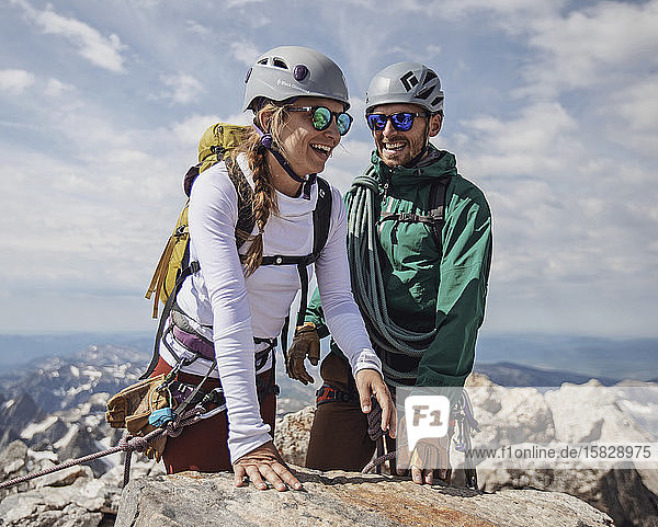 Couple smiles with joy after reaching summit of Grand Teton  Wyoming