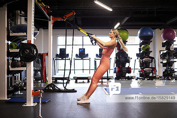 An athletic woman putting in time at the gym.