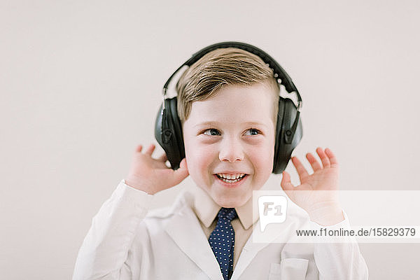 child in labcoat with headphones