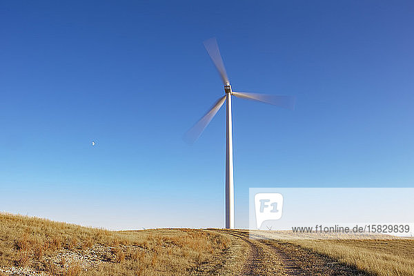 Windturbine in Bewegung gegen blauen Himmel