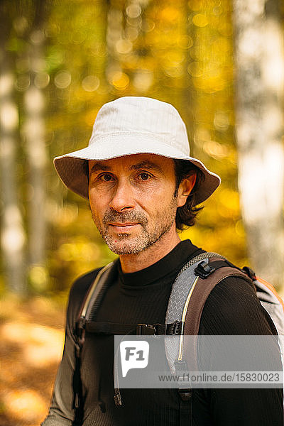 Close-up portrait of tourist man in panama hat. Colorful bokeh
