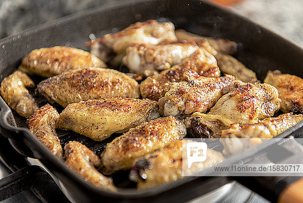 Close up of grill with chicken wings.