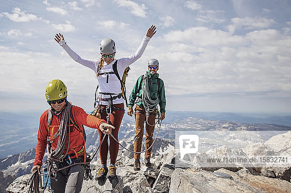 Three rock climbers celebrate reaching summit of Grand Teton  Wyoming