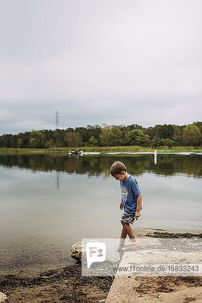 Young Boy Dipping Toes in the Water at Lake Bastrop