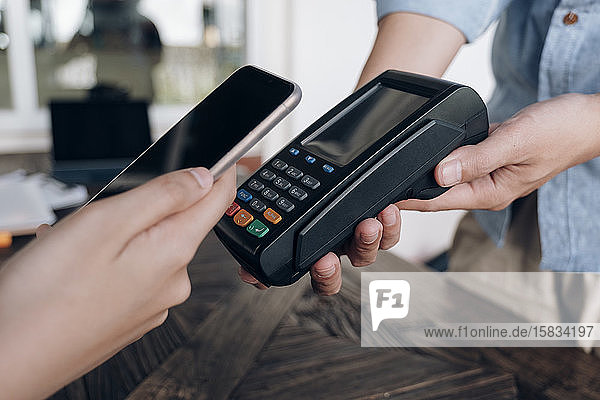 Paying bill through smartphone using NFC technology.