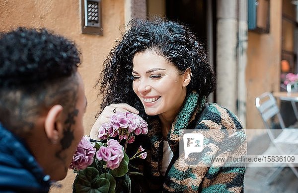 woman having coffee with her boyfriend sat at a cafe outside in Europe