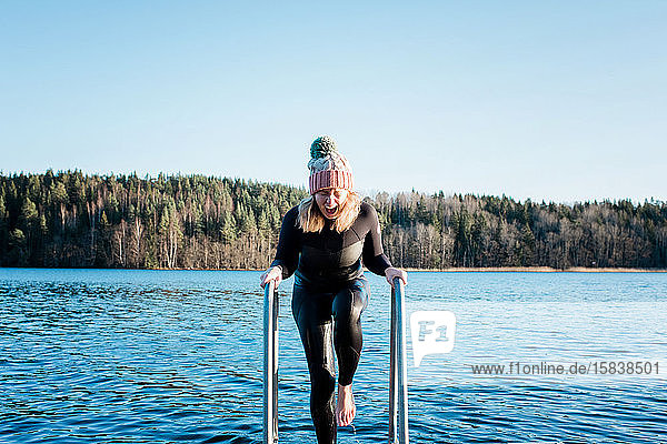 woman screaming from swimming in the cold water in the sea in winter