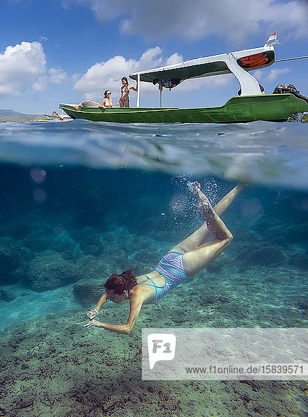 Young women have a fun in ocean  underwater view