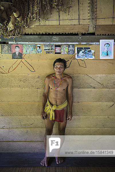 Porträt eines Mannes des Mentawai-Stammes mit Fotos seiner Kinder
