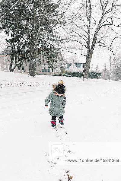 Little toddler girl in the snow.