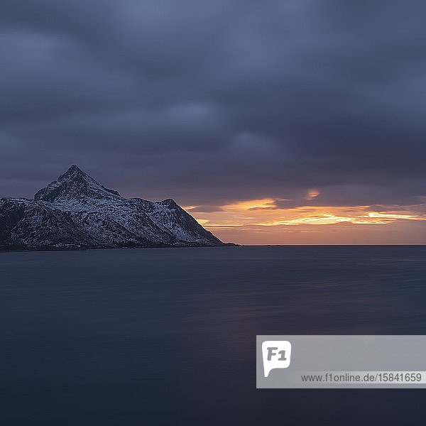 Stornappstind mountain peak rises over Nappstaumen Lofoten Islands Norway