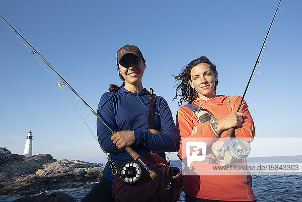 Portrait of two women fly fishing