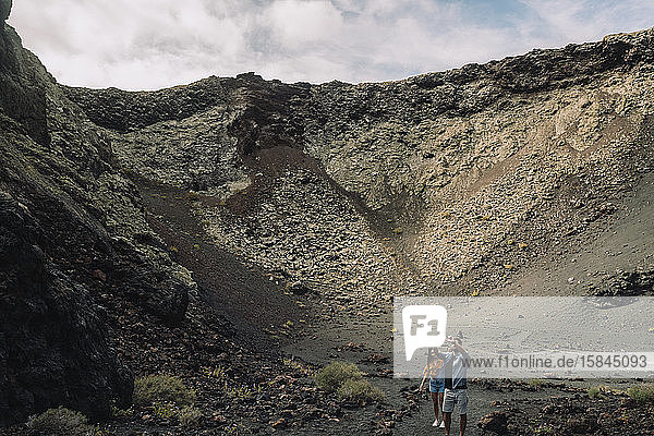 Couple taking a selfie inside of the Volcano Cuervo in Lanzarote.