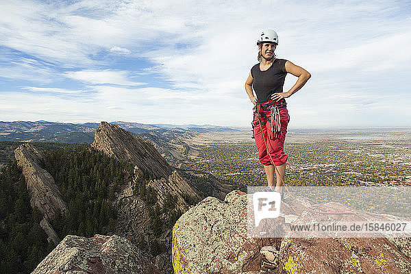 Woman rock climber on summit of Third Flatiron  Boulder  Colorado