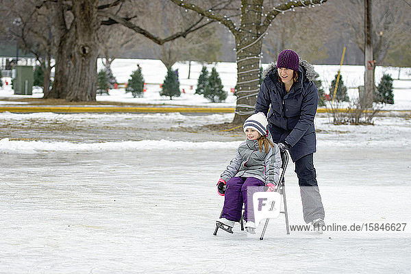 Mother Having Fun Ice Skating With Daughter