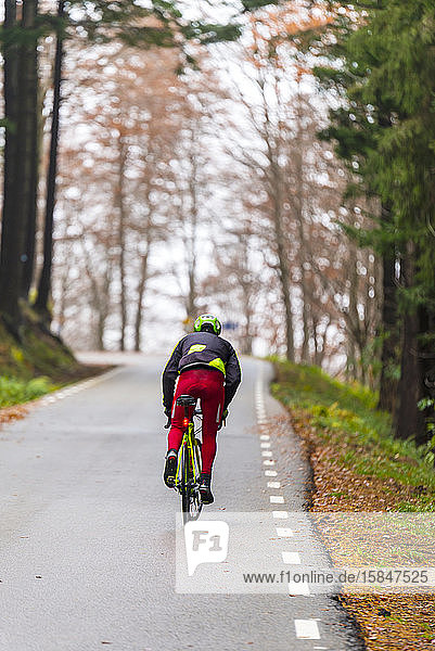 Male cyclist on foggy mountain road